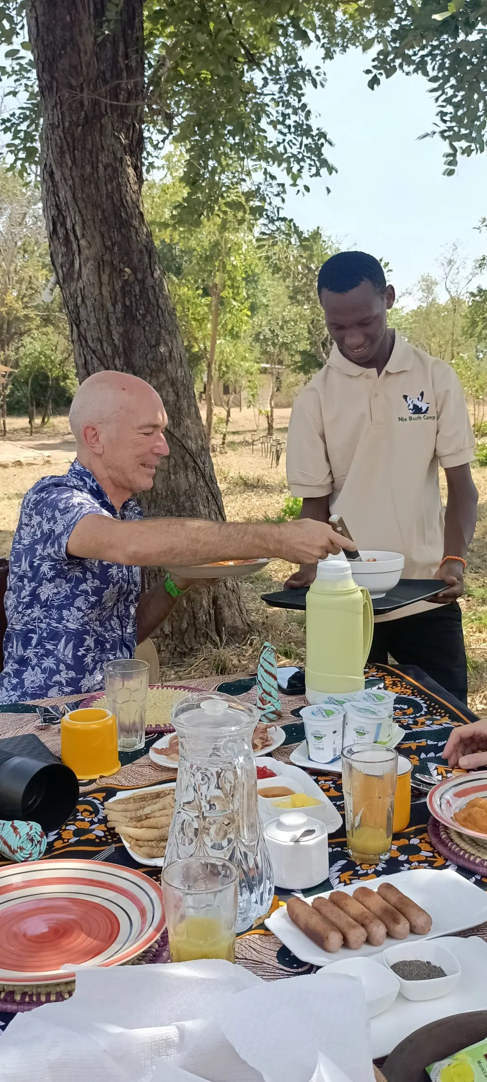 Nje Bush Camp team member serving breakfast to a guest