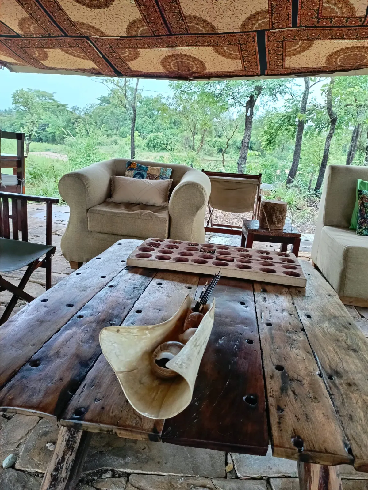 Locally styled lounge area looking out to the surrounding wilderness